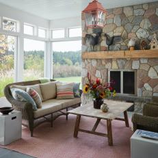 Country Sunroom With Stone Fireplace Surround