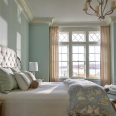 Traditional Coastal Bedroom With Crown Molding and Pale Blue Walls 