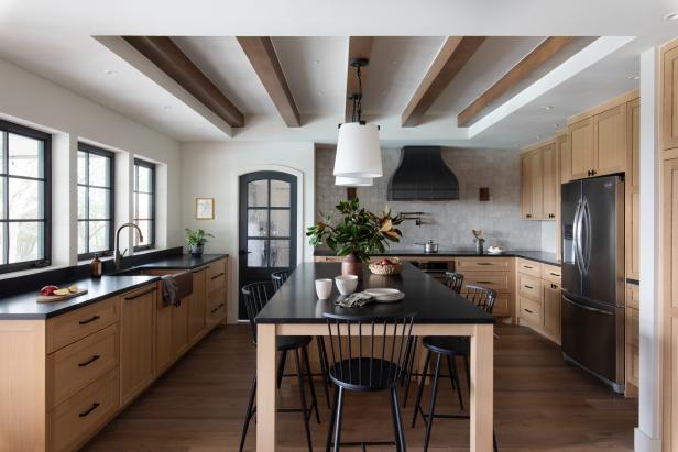 Kitchen With Island, Wood Accents, Black Chairs, Windows, Range Hood