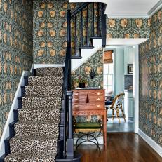 Eclectic Foyer With Leopard Print Staircase and Art Deco Wallpaper 