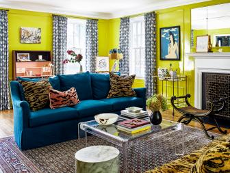 Bright green living room with turquoise sofa, acrylic table and art.