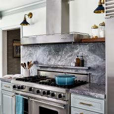 Transitional Kitchen With Dramatic Stone Backsplash, Chef's Stove and Gold Accents