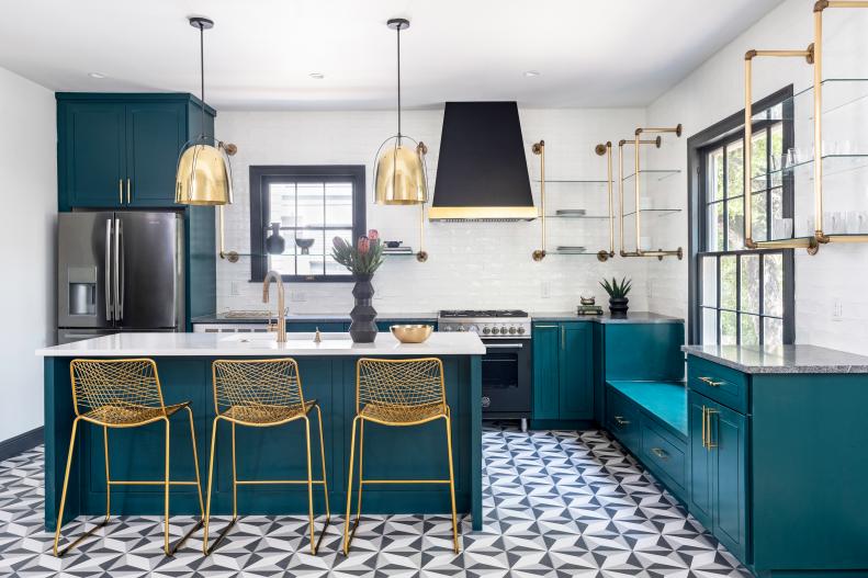 Kitchen with teal cabinets and gold accents. 
