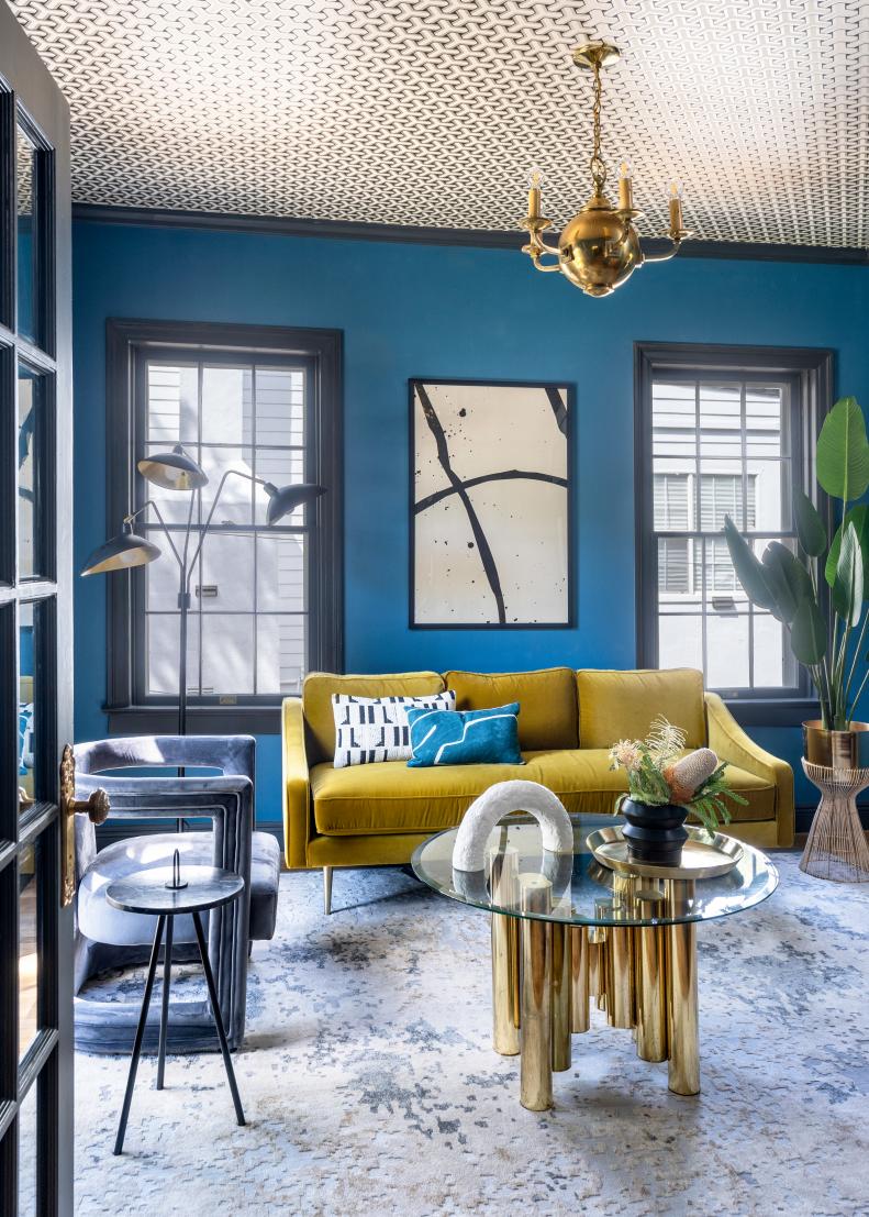 Teal room with graphic ceiling and Art Deco furnishings.