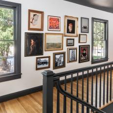 Gallery Wall With Black Ceiling and Hardwood Floor