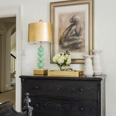 Dresser With Gold and Green Lamp