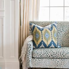 Blue Cheetah Print Sofa and Ikat Pillow