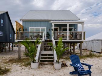 As seen on HGTVÕs Battle on the Beach, the exterior of the beach house after the team mentored by Alison Victoria redesigned it as a part of the design challenge. Design highlights include a lounge area with a fire pit near the steps to the front porch.