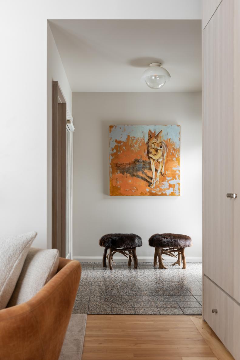 The coyote painting punctuating this hallway celebrates Montana wildlife in a style that suits the home’s on-trend terrazzo floor tile and sleek, flush-mount globe light. (Fancy something similar for your own home? Take a virtual stroll through a curated collection of environmental art like Jackson Hole, Wyoming’s Gallery Wild.) The pair of antler-leg stools, in turn, offer a contrasting, traditionally Nordic take on the mountain aesthetic.