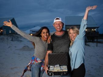 As seen on HGTV's Battle on the Beach, mentor Taniya Nayak, Kerry and David pose with a briefcase of $50,000 after being announced as the ultimate winner of Battle on the Beach.  Three teams competed to renovate beach houses for the ultimate prize of $50,000.  (Winner)