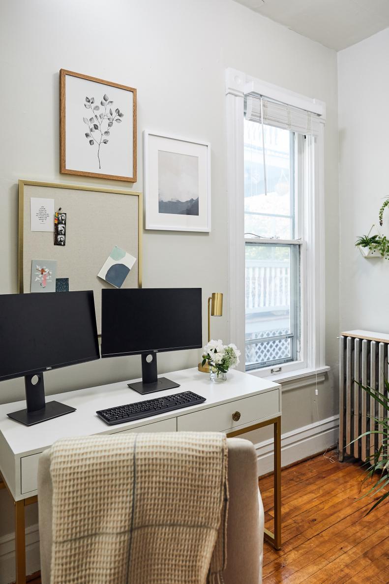 A secondhand, updated desk and a new upholstered office chair by a window.