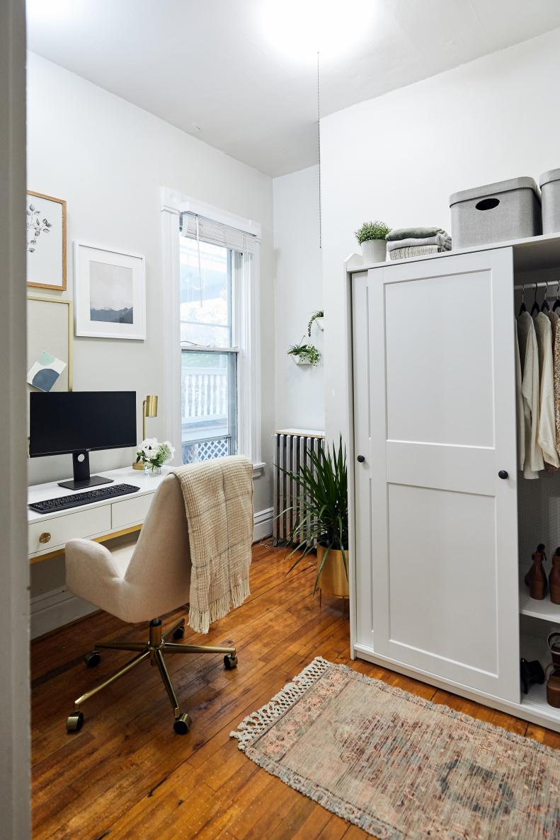 An updated home office space with a chair, computer and closet