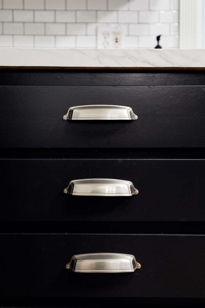 Brushed nickel cup pulls on kitchen drawers put a modern twist on cottage style.