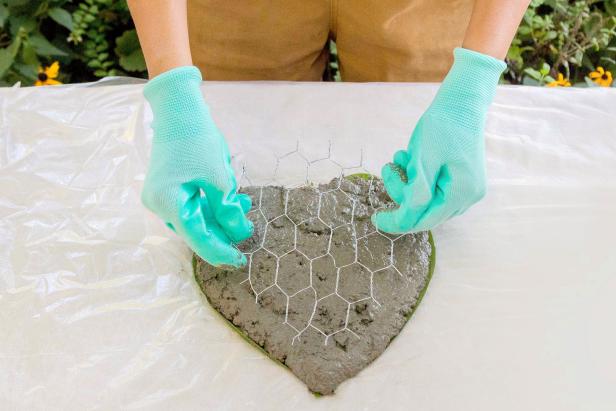 Place the chicken wire on top of first layer of concrete the apply second layer of concrete. Do not skip the chicken wire, it will strengthen the structure and reinforce the concrete so it won’t crack.