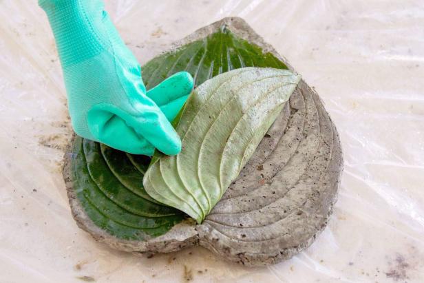 After the concrete has set a bit, remove the plastic. Gently flip and peel the leaf off the concrete.