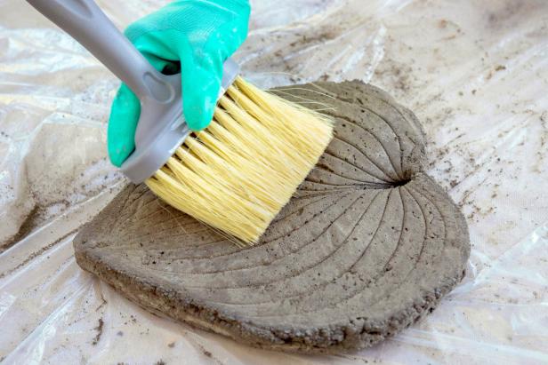 After the concrete has set a bit, remove the plastic. Gently flip and peel the leaf off the concrete. Use a wire brush to smooth the edges. Allow the concrete to harden for 24-48 hours.