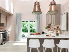 Blush and rose gold collide with soft grays and clean whites in the HGTV Urban Oasis 2021 kitchen to create an open, airy space that's full of character.