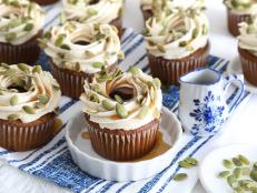 There's no better way to welcome fall than with a batch of homemade pumpkin-maple cupcakes topped with maple frosting, a maple syrup drizzle and pumpkin seeds.