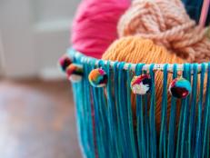 Blue twine basket full of yarn balls 