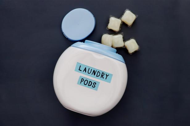 Remove all labels from your empty laundry pod container. If they are being stubborn, try loosening them with hot water or adhesive remover. Then pop the top plastic piece off so you’re left with just a round container.