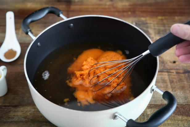 Whisking Pumpkin Puree and Apple Cider in Large Pot