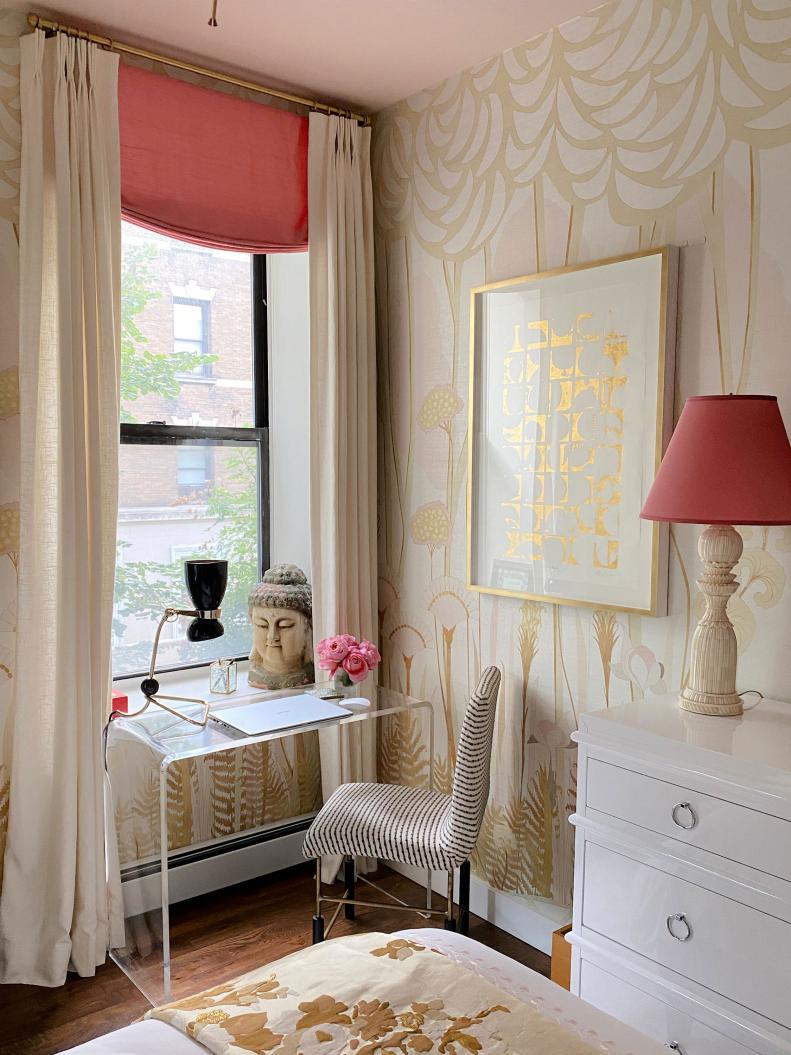 Function meets fashion in this niche corner of a bedroom where a window provides lots of natural light. Stylish accessories include a Lucite desk, black and white striped chair, hourglass-shaped desk lamp and inspirational Buddha head. 