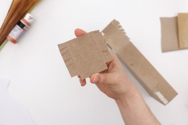 If needed, glue the excess cardboard from the previous step to the other side to extend it. Glue that side in place the same way.