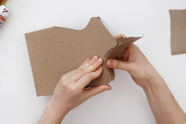 If needed, glue the excess cardboard from the previous step to the other side to extend it. Glue that side in place the same way.