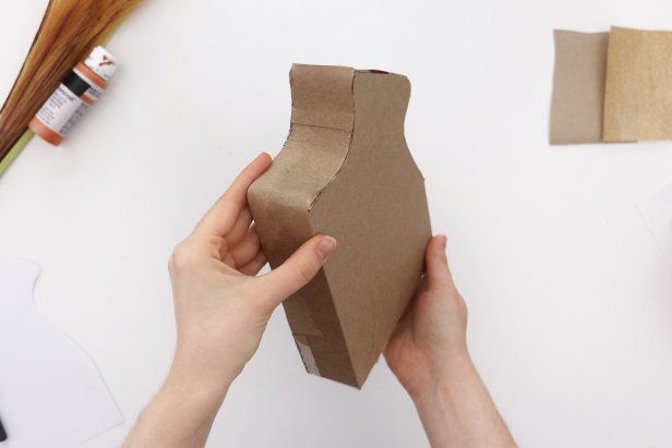 If needed, glue the excess cardboard from the previous step to the other side to extend it. Glue that side in place the same way.