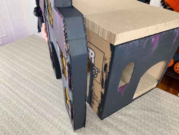 Line up the facade’s doorway to the cut doorway of the box. Add an ample amount of hot glue to the box and carefully press the facade to it. Plug it in and get spooky!!