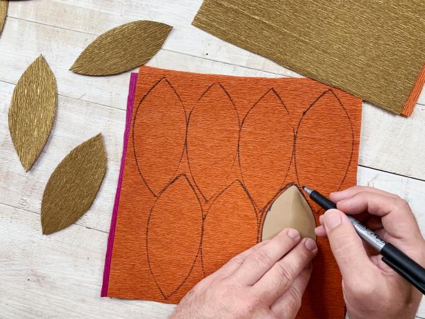 Trace the leaf template onto the crepe paper and cut out each leaf. Be sure to be strategic when tracing so that you get as many leaves as possible.