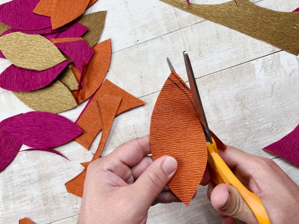 Trace the leaf template onto the crepe paper and cut out each leaf. Be sure to be strategic when tracing so that you get as many leaves as possible.