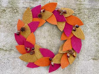 Wreath with purple, gold and orange leaves, acorns and pine cones 