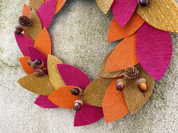 Gently pull up the leaves and glue downfall festive flourishes evenly spaced around the wreath to complete the look. Tip: Get creative with this, go outside and collect mini pinecones, acorns, or even branches.