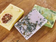 Handmade Melt-and-Pour Soaps on Table With Dried Lemon, Lavender