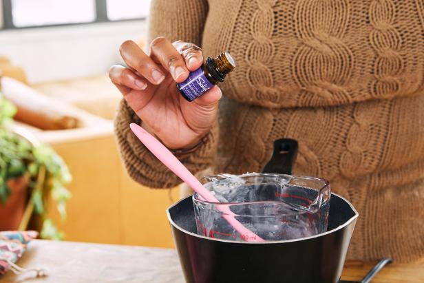 Once the soap is melted, add 20-22 drops of your favorite essential oils, like peppermint oil or lavender to the mixture. Mix the ingredients with a spatula. Next, add in some color using 3 drops of water-based liquid dye. Then add dried mint leaves or jasmine buds for added texture and fragrance. Stir mixture with spatula.