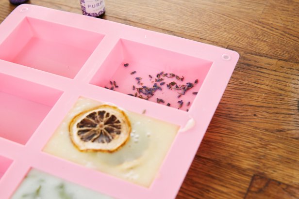 Add dried mint leaves, jasmine buds or a slice of dried lemon for added texture and fragrance to the base of the silicon mold. Then, pour in the melted soap mixture.