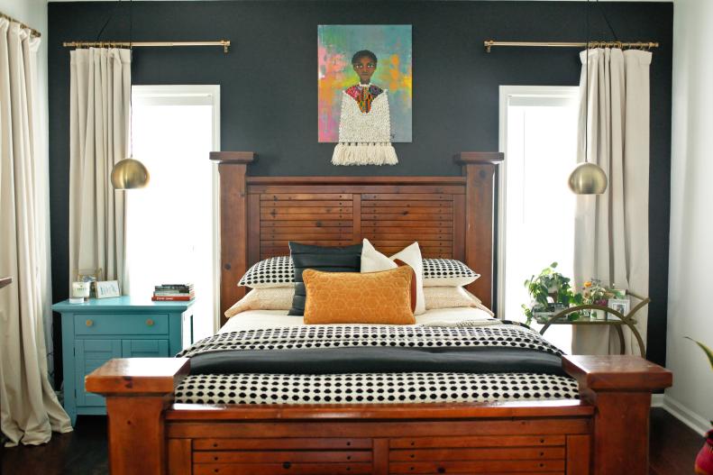 In her bedroom, Laquita opted for a soothing feel with a few artistic flourishes. “The artwork and bed frame stand out beautifully against the black accent wall,” she says. Some of the room’s surprise touches include the tassel extensions at the bottom of the artwork and 2 light fixtures hanging over the nightstands. “I used a bar cart instead of a standard nightstand beside the bed because I love using pieces with traditional uses in different ways.” 