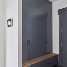 A Slate Gray Mudroom Entryway with Hidden Shoe Storage