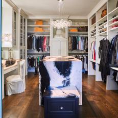 Walk-In Closet with Natural Stone Island and Vanity with Crystal Lighting