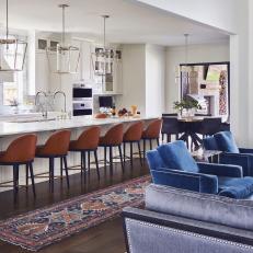 An Open-Concept Living Room and Kitchen with Leather Bar Stools