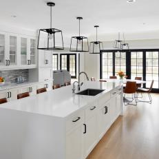 White Transitional Open Plan Kitchen With Black Doors