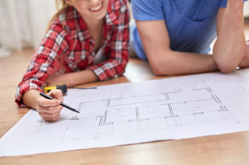 Man And Woman Plan Renovations And Building In Their Home
