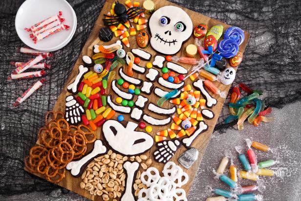 Charcuterie Board With Skeleton-Shaped Cookies Surrounded by Halloween Candy