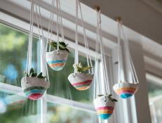 Learn how to make clay pinch pot hanging planters, perfect for mini succulents, with just a few materials and this easy, step-by-step tutorial.