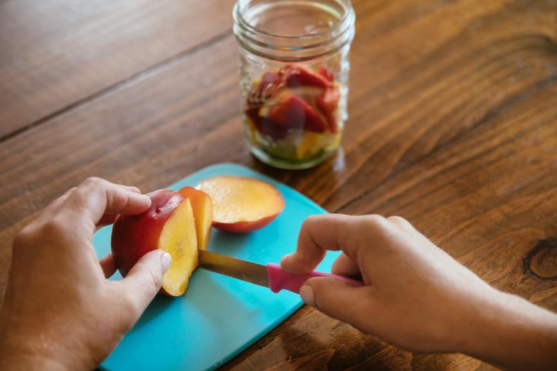 Cutting a Nectarine for a Camping Cocktail Recipe