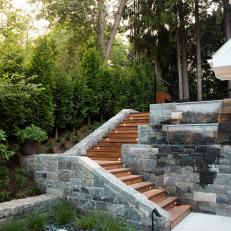 Contemporary Backyard with Terrace Steps and Stone Waterfall
