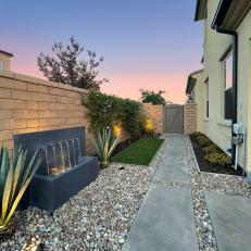 Fountain in Contemporary Backyard Featuring Stone Pathway