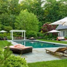 Backyard With Pool and Orange Cushions