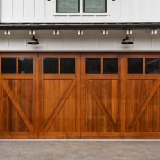 White Farmhouse with Light Wood Garage Door